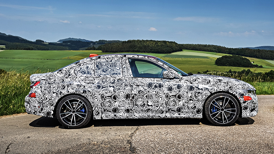 BMW 3 Series in action. Side view of the disguised BMW 3 Series prototype on the racetrack.
