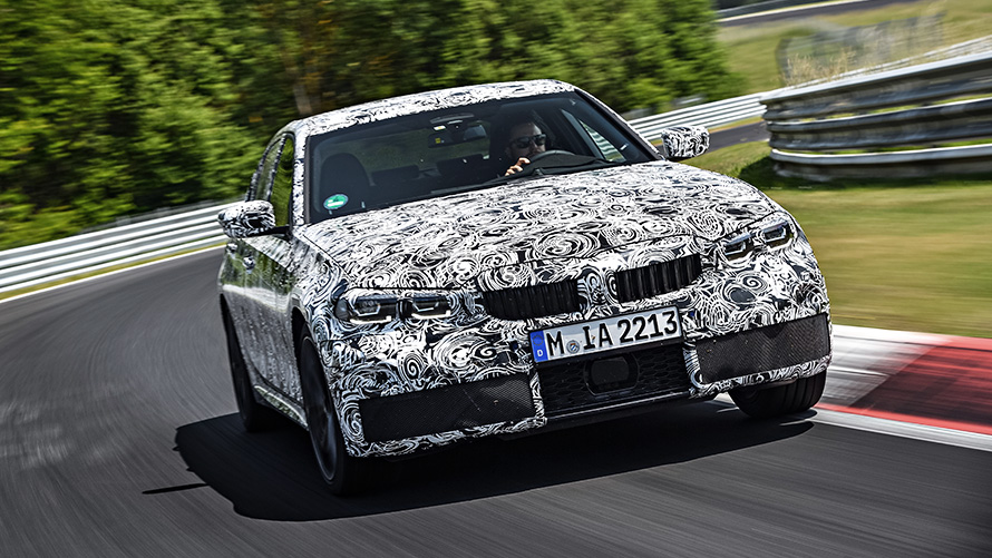 BMW 3 Series in action. Front view of the disguised BMW 3 Series prototype on the racetrack.