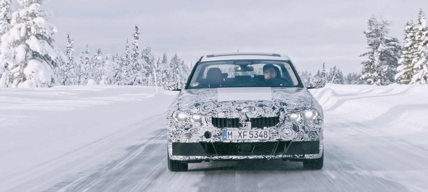 BMW 3 Series in action. Disguised prototype of the BMW 3 on snow in the wilds.