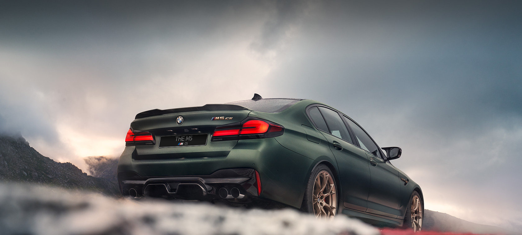 BMW M5 CS F90 2021 Frozen Deep Green metallic rear view low angle shot 