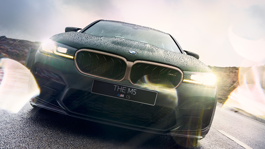 BMW M5 CS F90 2021 Frozen Deep Green metallic front view with headlights on
