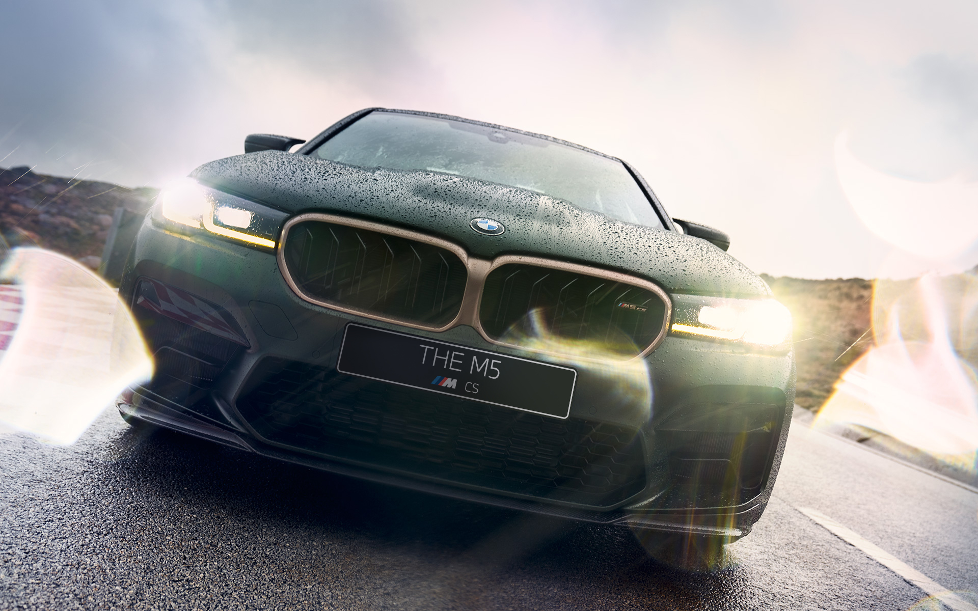 BMW M5 CS F90 2021 Frozen Deep Green metallic front view with headlights on